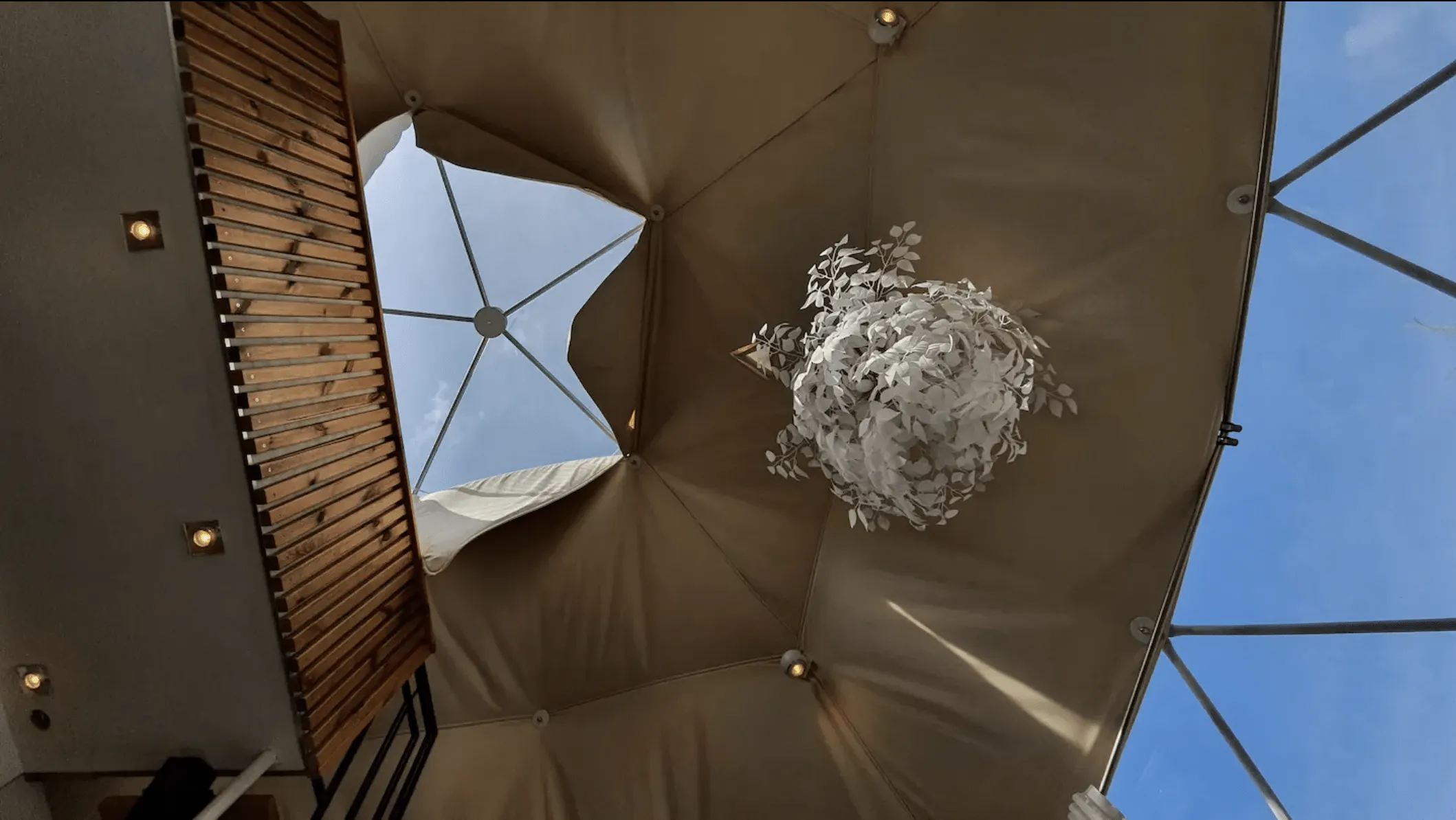 inside of geodesic dome with a skylight and a window