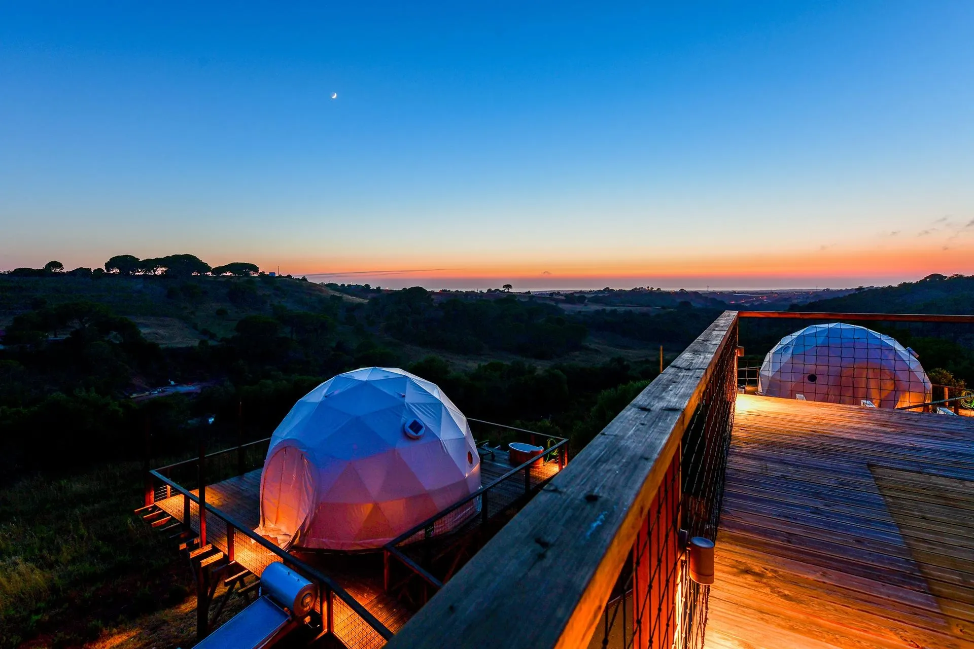 white geodesic domes on the mountainside at night