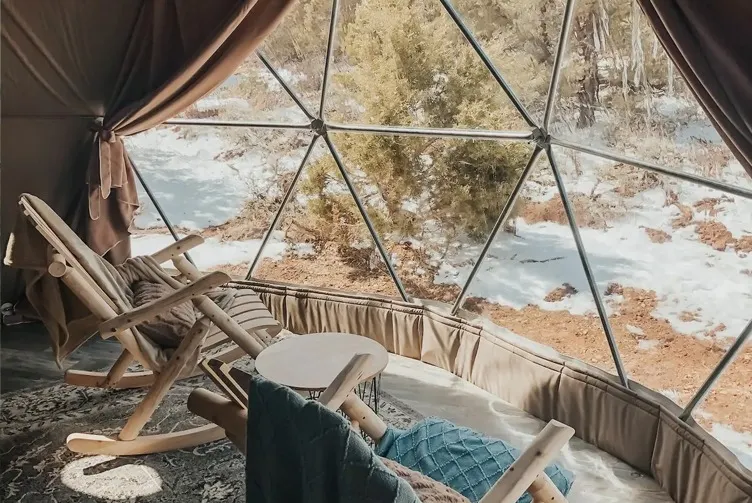 interior of geodesic dome with view at window, chairs and table coffee