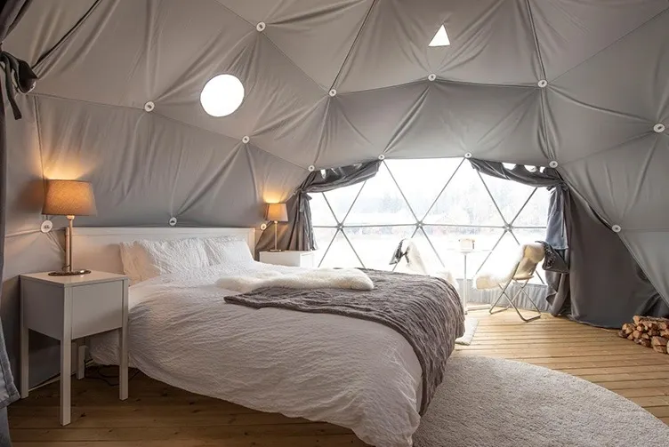Interior of geodesic dome with view of window and bed