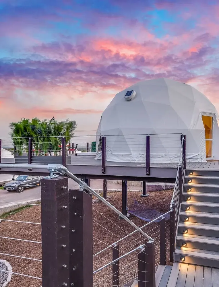 white geodesic dome on platform on the hill