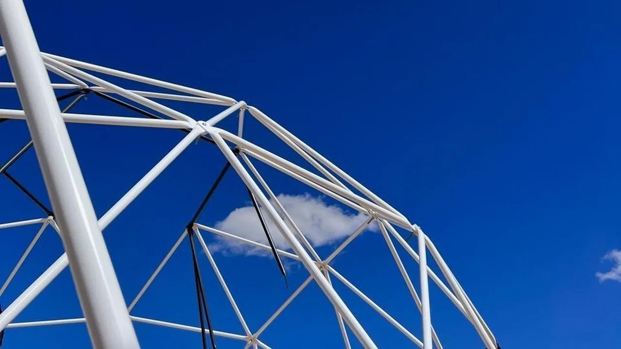 glamping geodesic dome structure blue sky