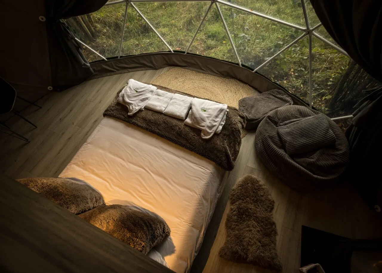 cozy interior of a dome cabin with bed during the late afternoon