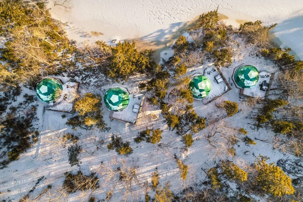 four geodesic domes on a beach in Canada during the day